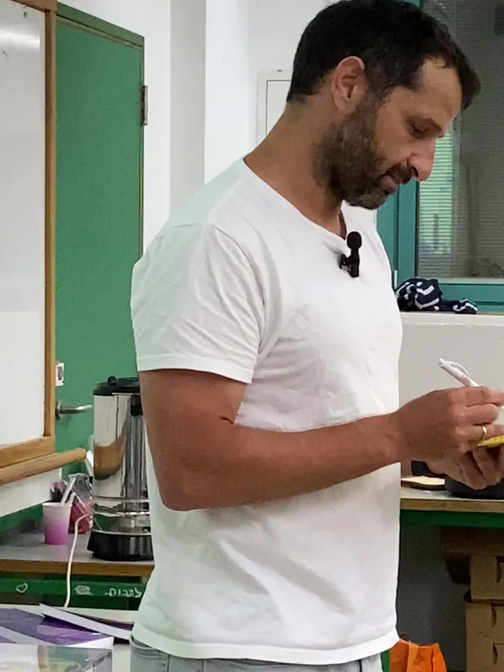 Alon Bar taking notes in a notepad during a workshop